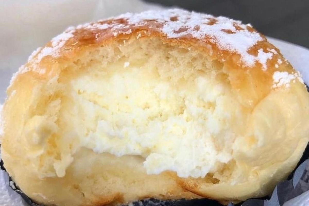 a close up of a doughnut with powdered sugar on it