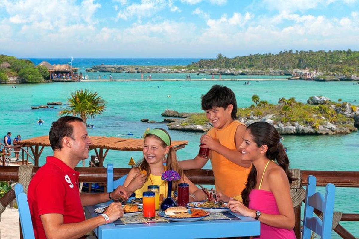 a group of people sitting at a table in front of the ocean