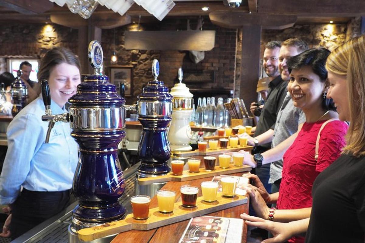 a group of people standing at a bar with drinks