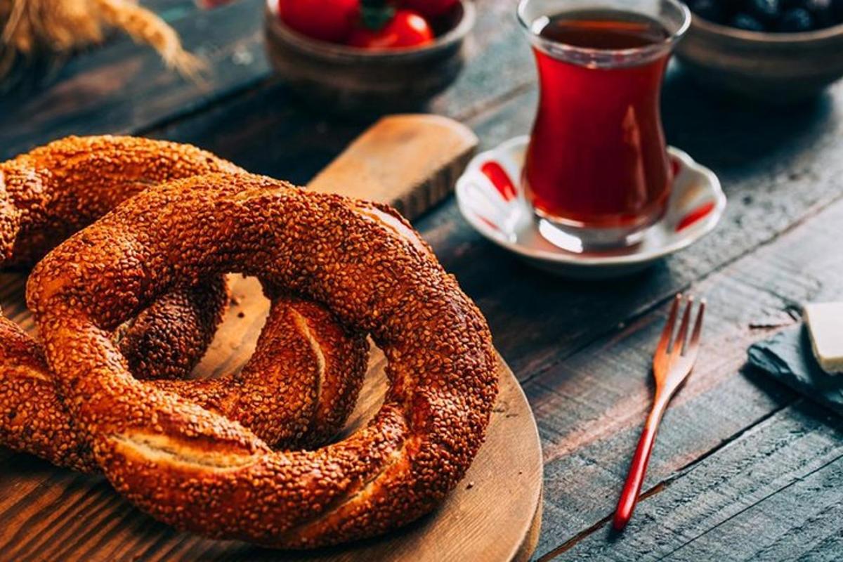 a wooden plate with a pretzel and a cup of tea