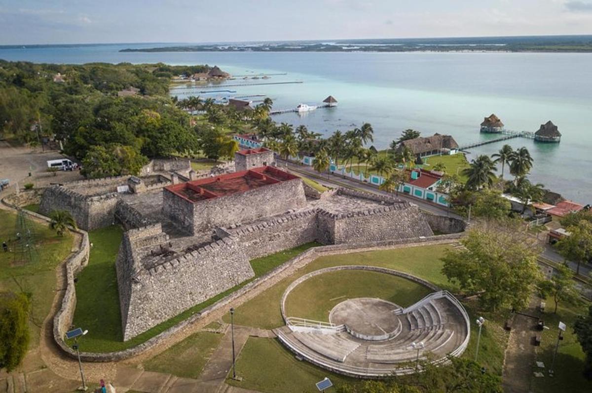 an aerial view of a castle next to the water