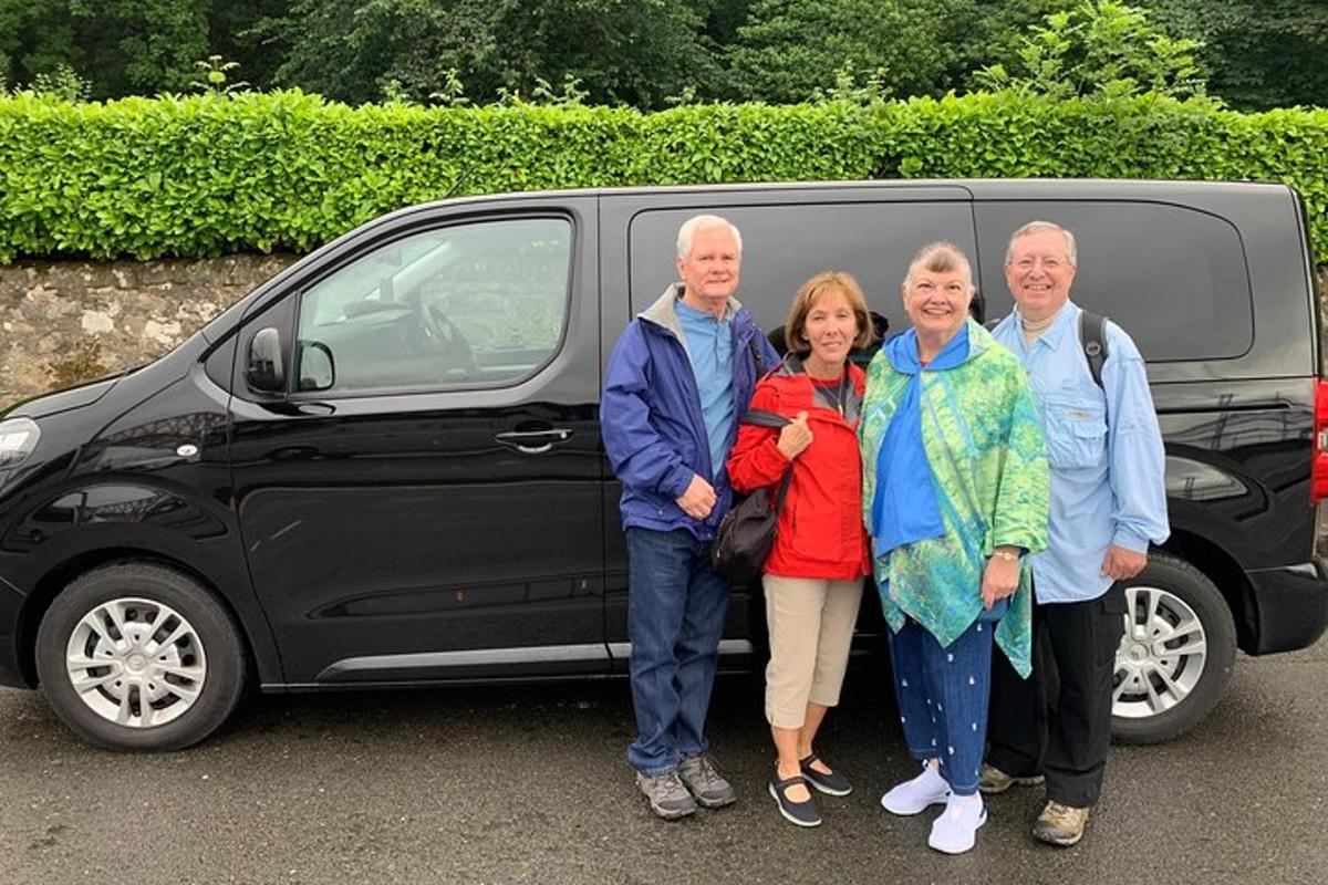 a group of people standing in front of a van