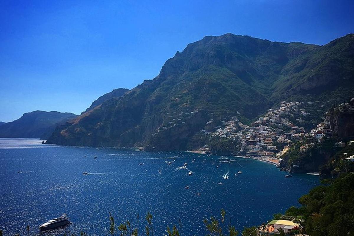 a large body of water with a town and mountains