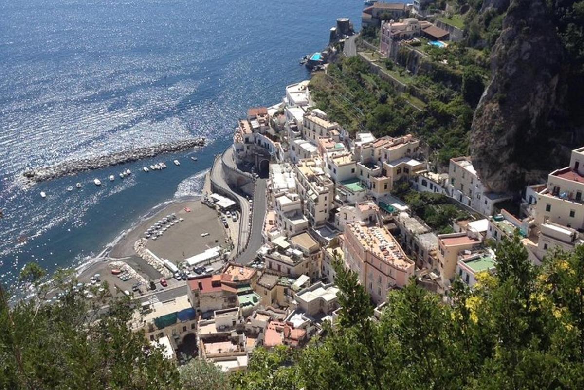 a village on the side of a mountain next to the ocean