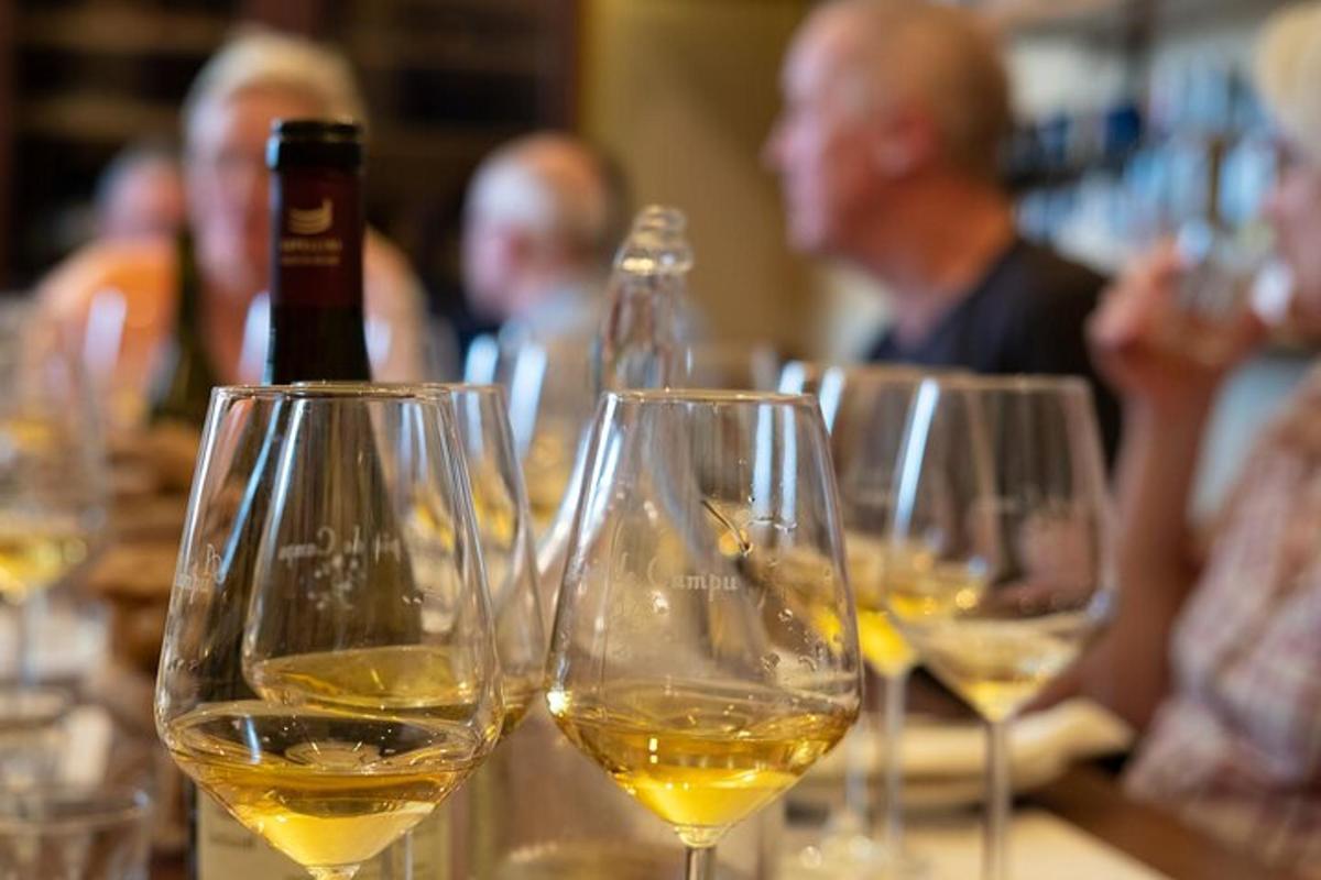 a group of glasses of white wine on a table