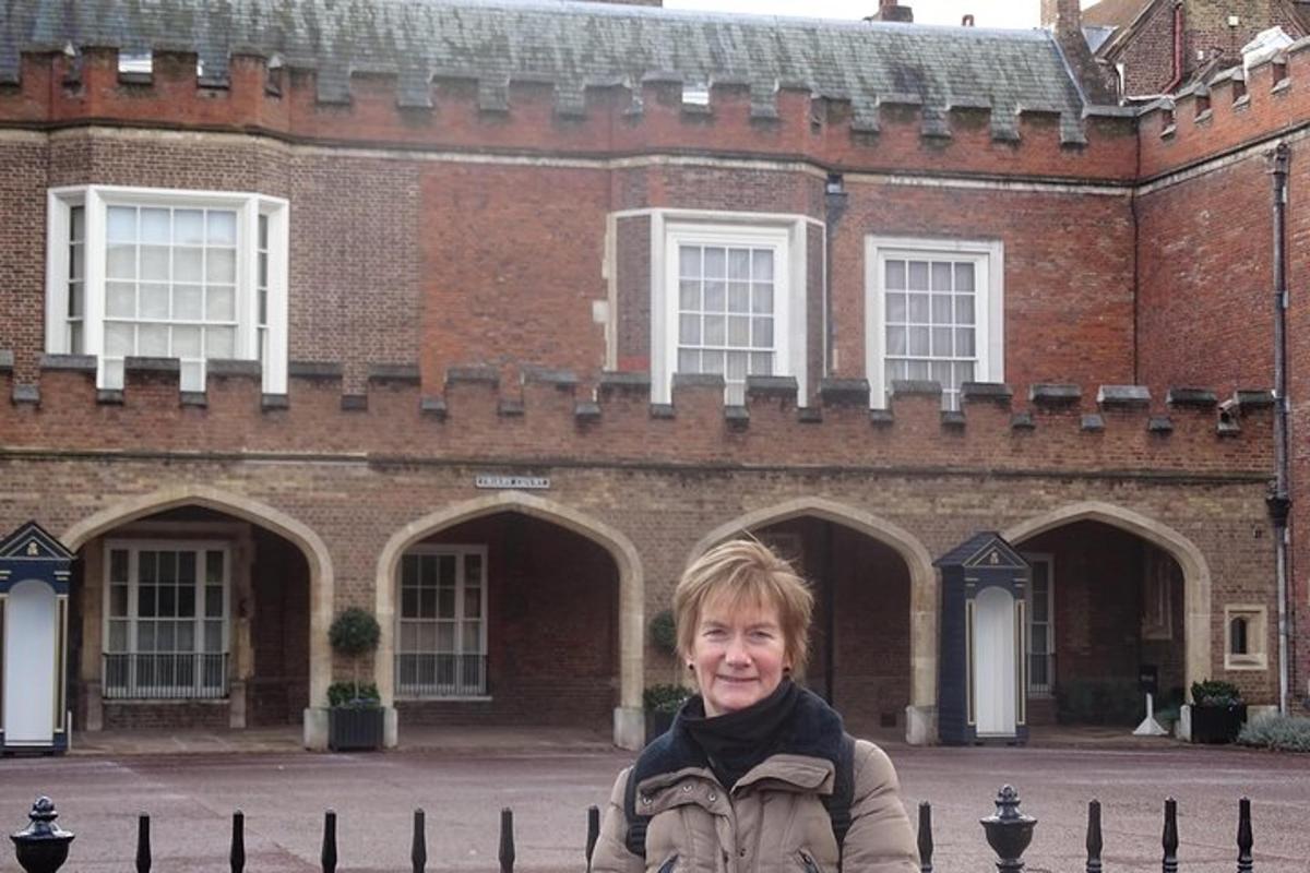 a woman standing in front of a brick building
