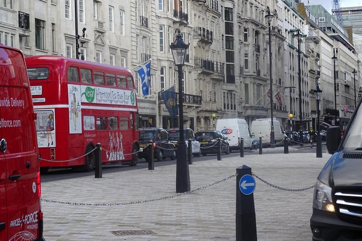 a red double decker bus on a city street