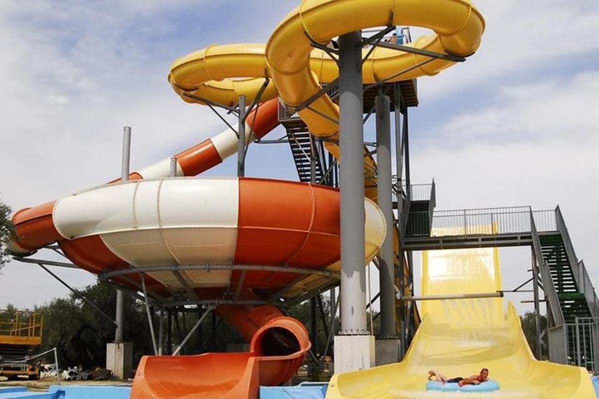 a person laying on a slide at a water park