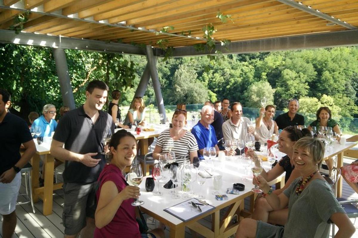 a group of people sitting at tables with wine glasses