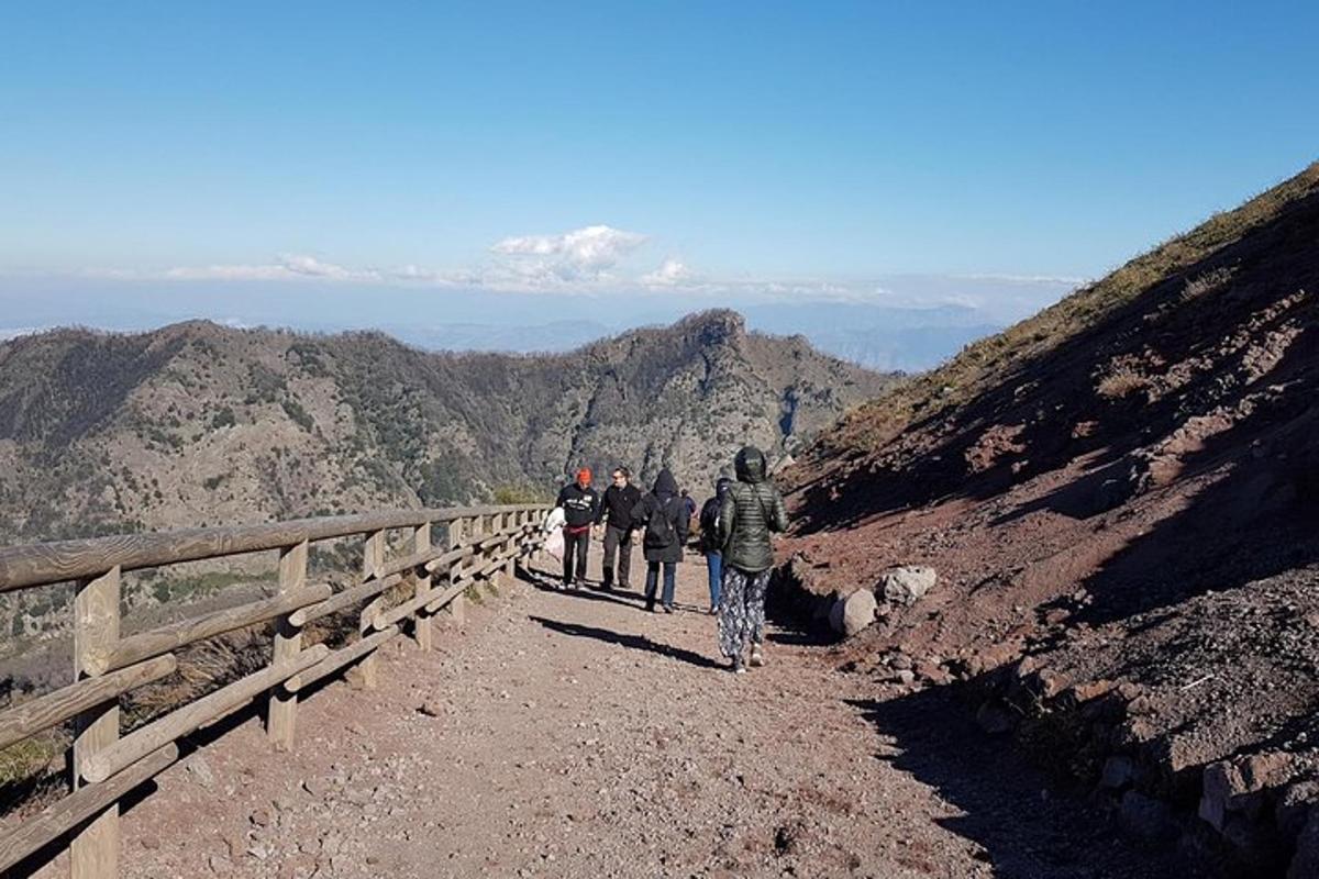un grup de persones caminant per un camí de terra per una muntanya