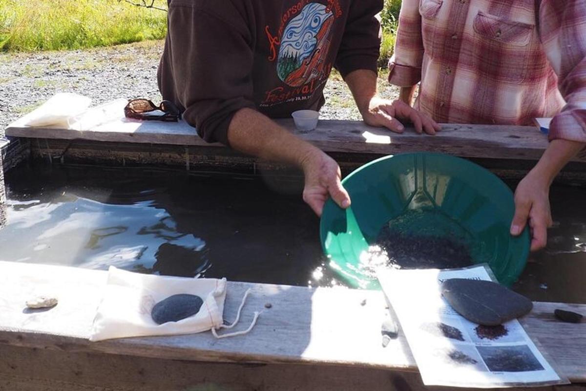 a man holding a green bowl in the water