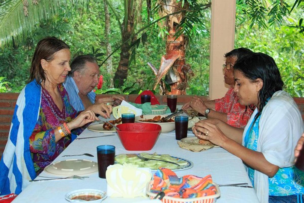 a group of people sitting at a table eating food