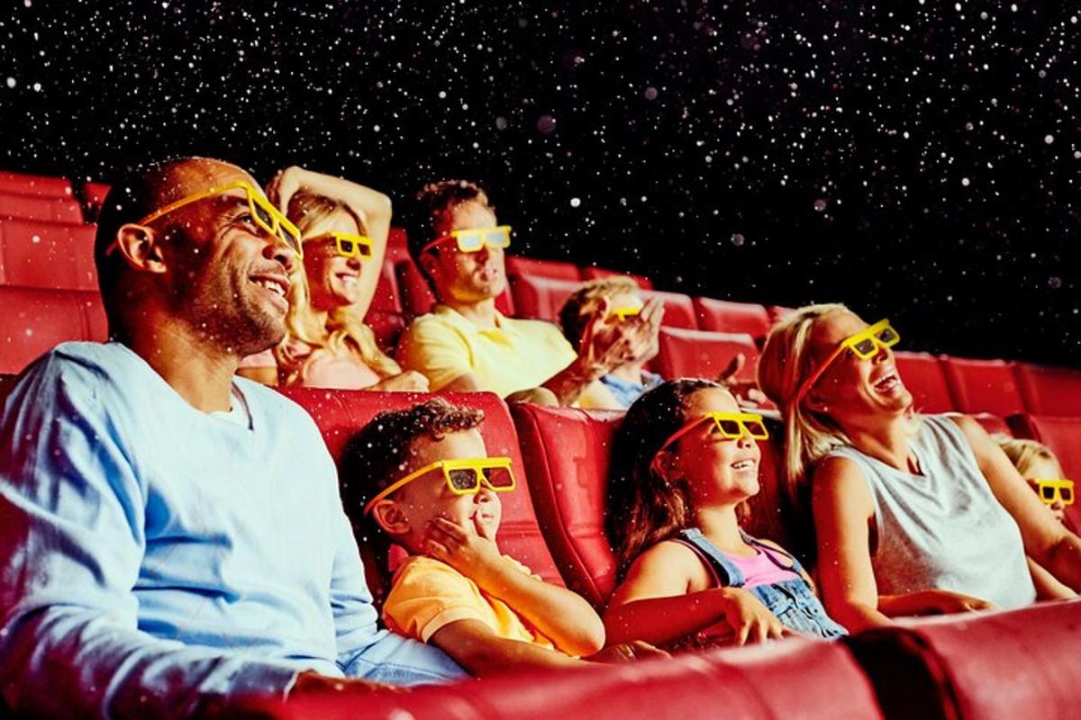 a group of people sitting in a theatre wearing sunglasses