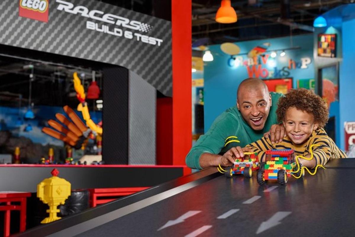 a man and a young boy playing with a toy car