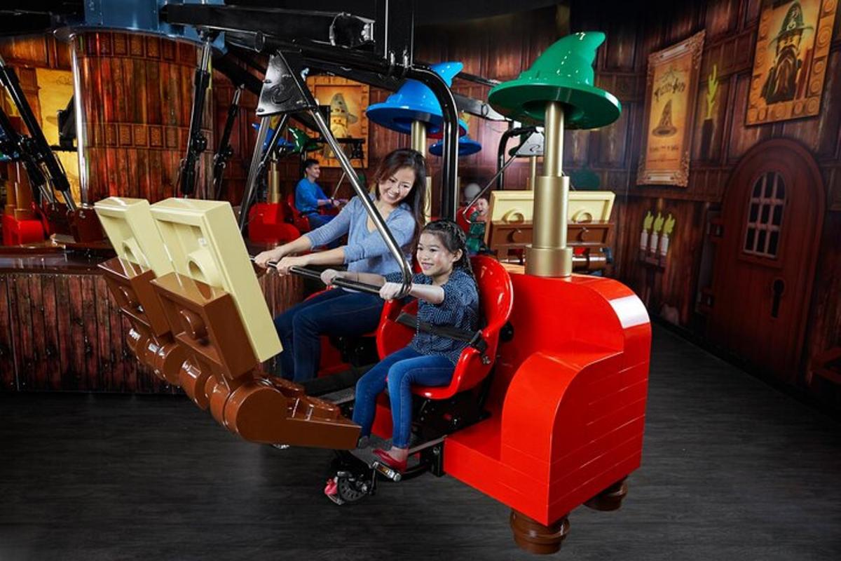 two women are riding on a roller coaster