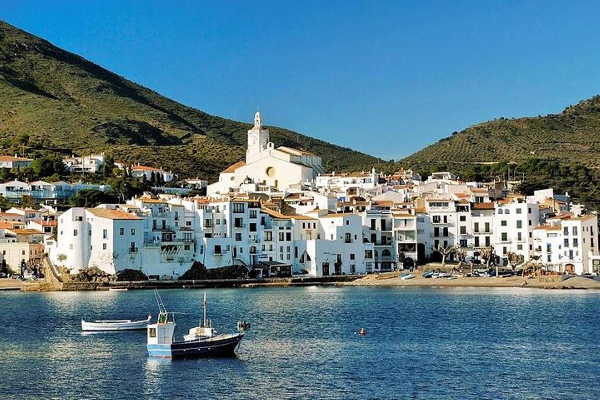 a group of white buildings with boats in the water