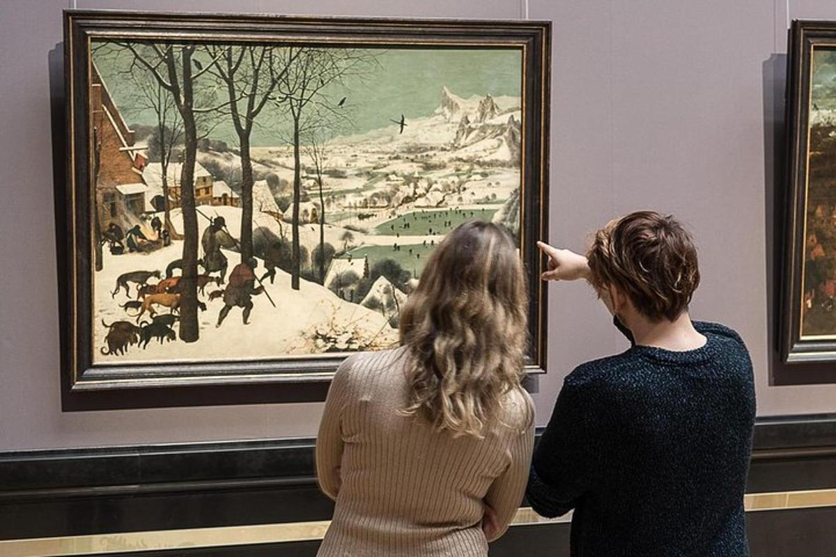 two women looking at a painting in a museum