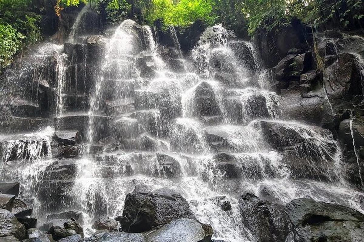 a waterfall on the side of a mountain with rocks