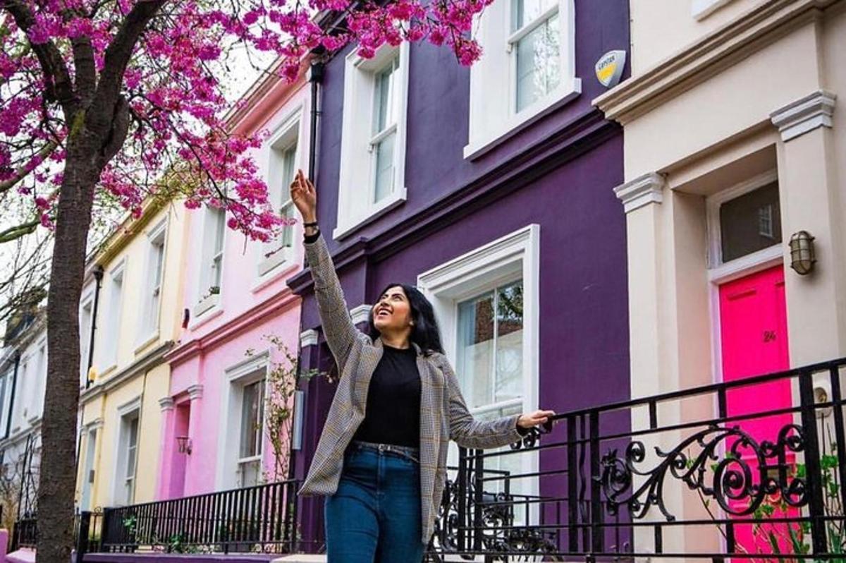 a woman standing in front of a purple building