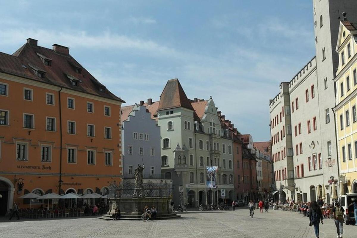 a city street with buildings and people walking around