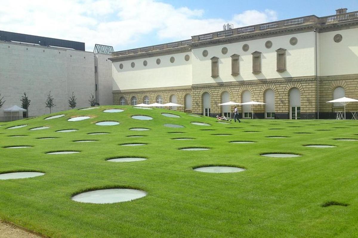 un grande campo d'erba di fronte a un edificio