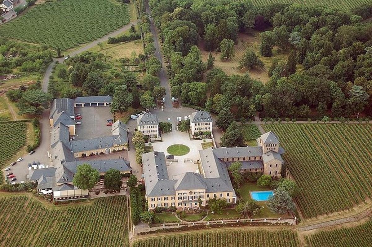 an aerial view of a large house with a yard