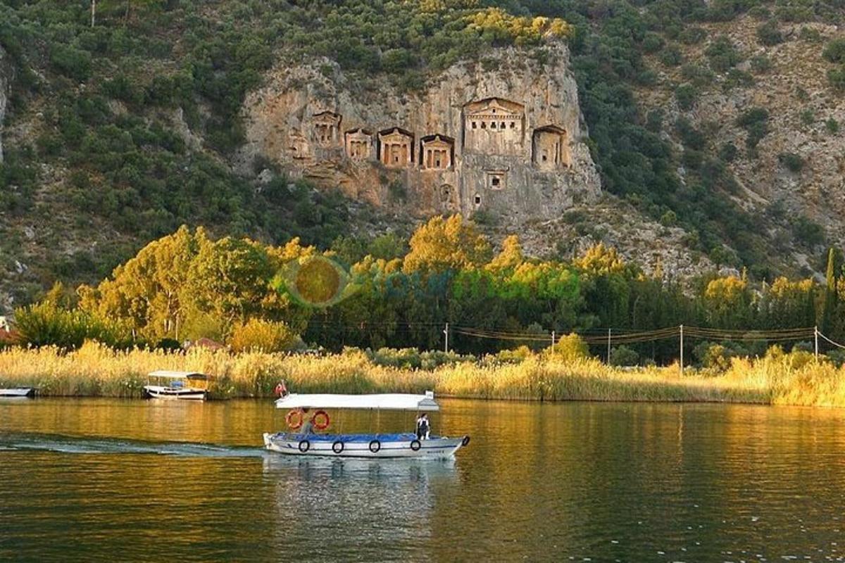 a boat on the water with a castle in the background