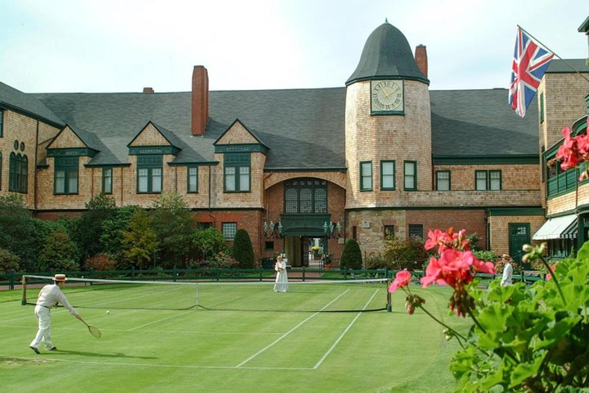 to personer som spiller tennis på en tennisbane foran en bygning