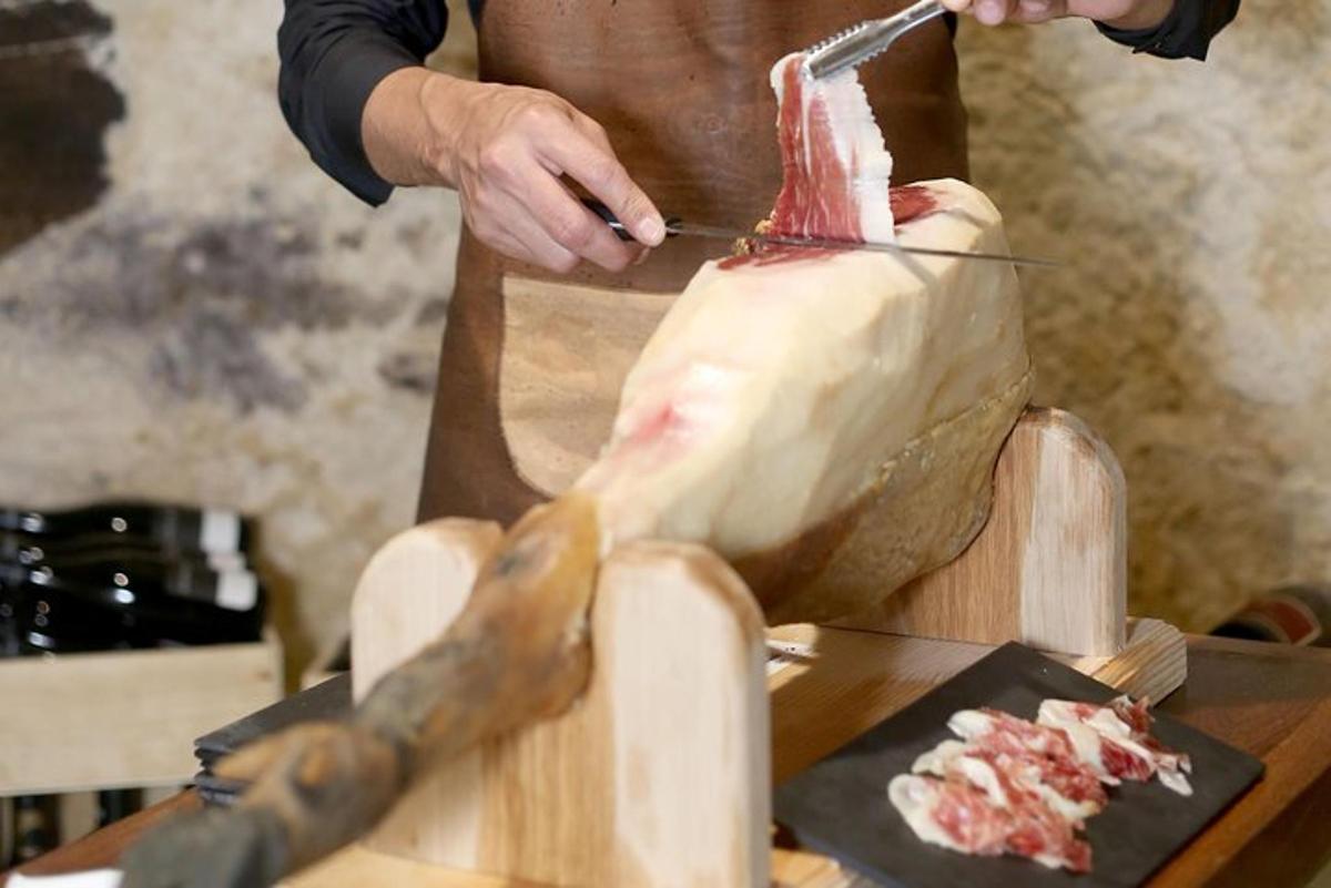 una persona che taglia un pezzo di carne con un coltello