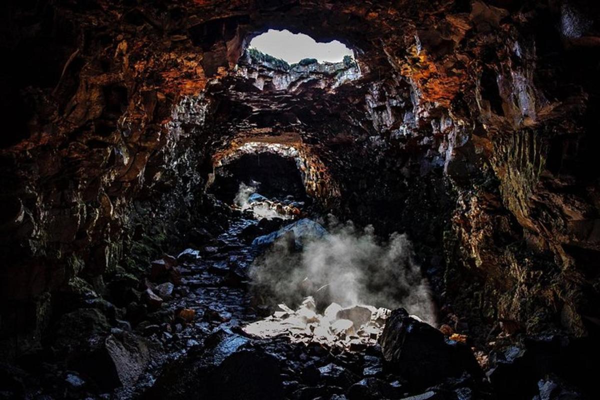 a view of a cave with steam coming out of it