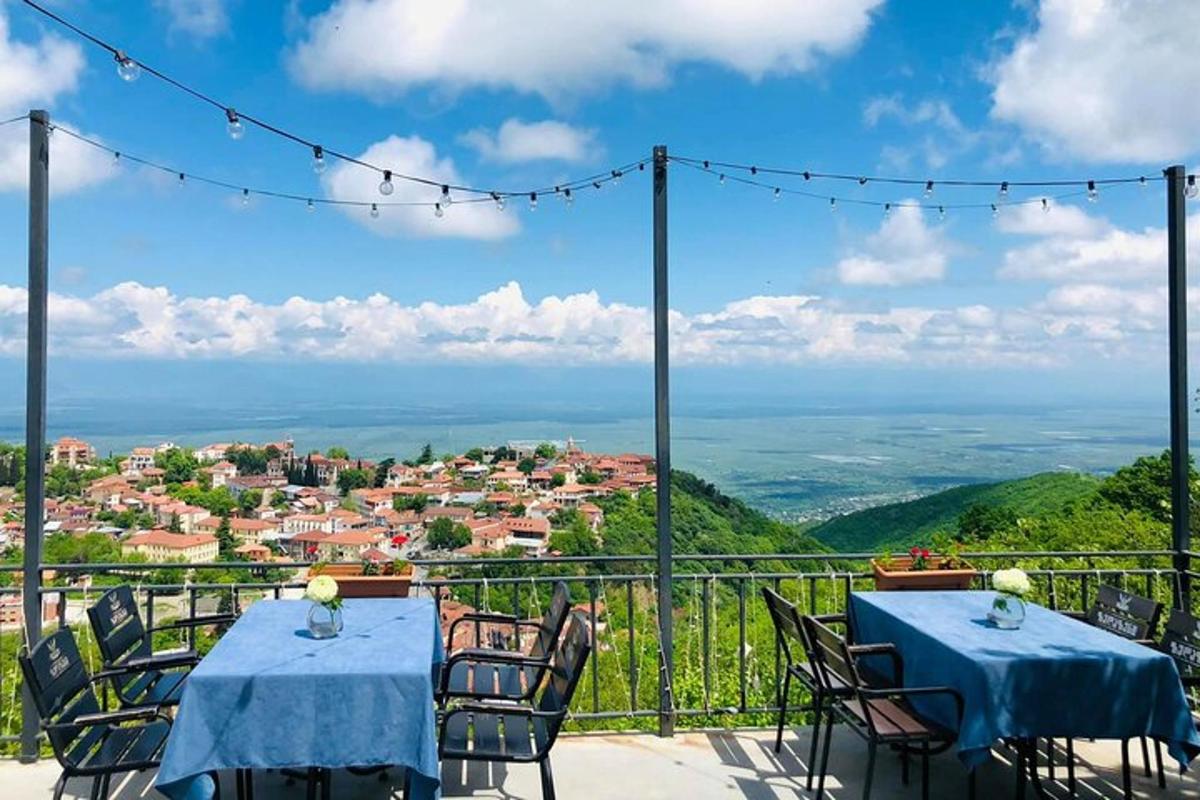 a table and chairs on a balcony with a view