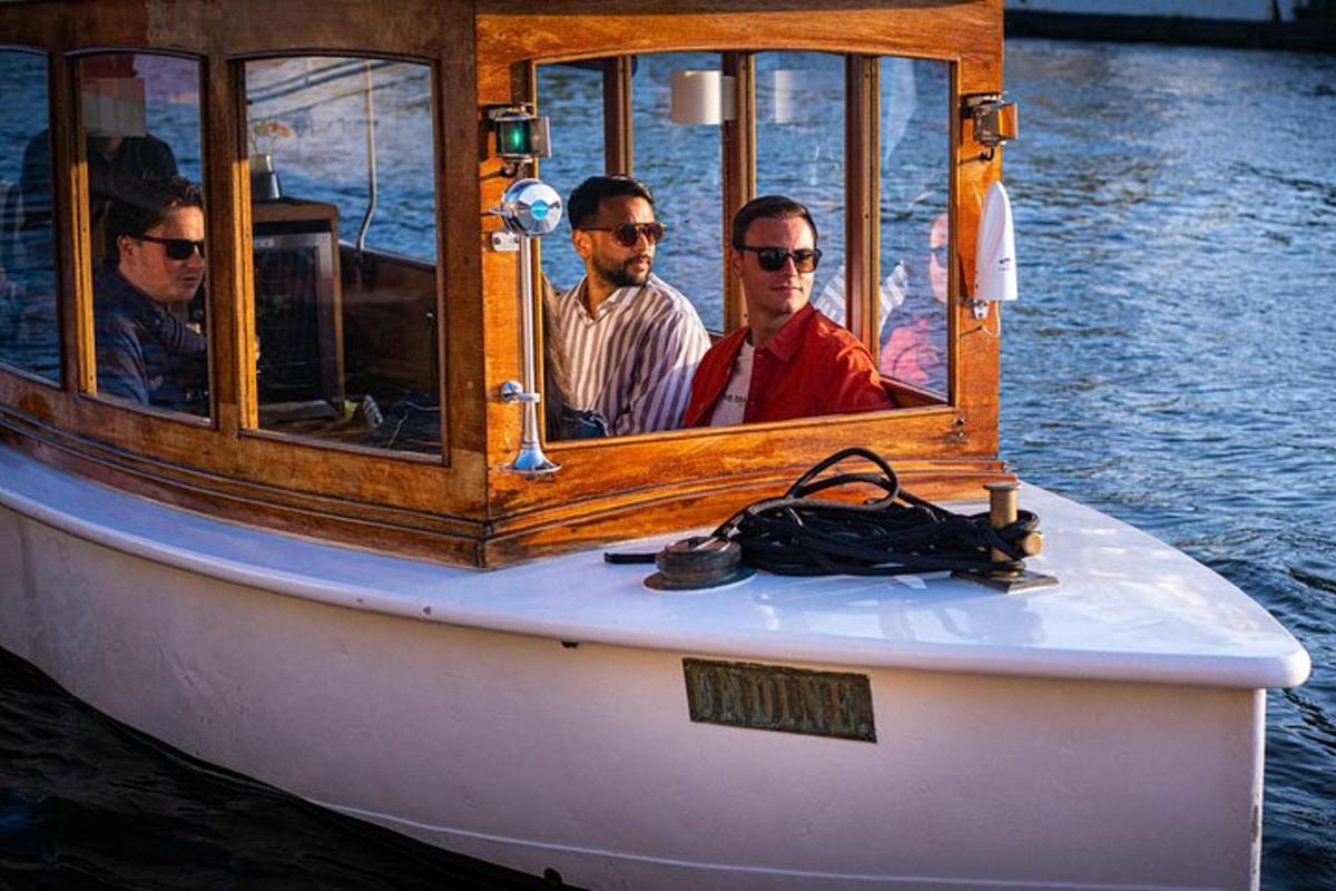 a group of men sitting on a boat in the water