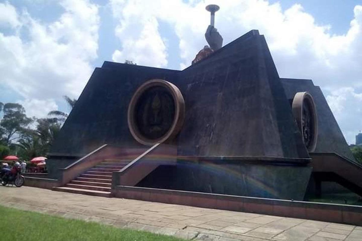 a statue of a person sitting on top of a stairway