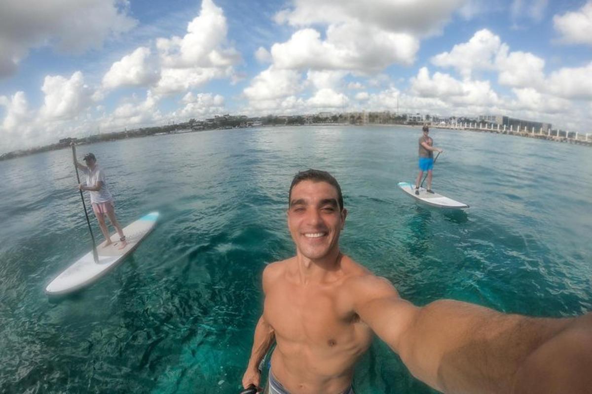 two men standing on surfboards in the water