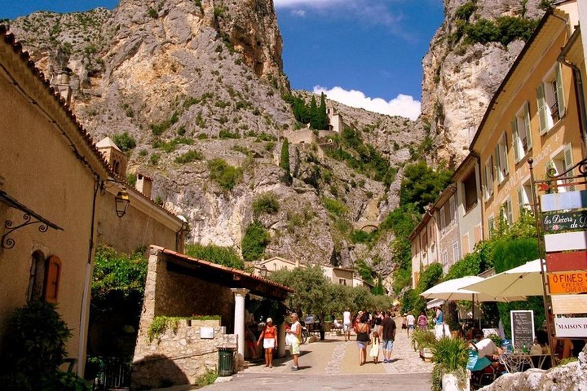 a group of people walking down a street with a mountain