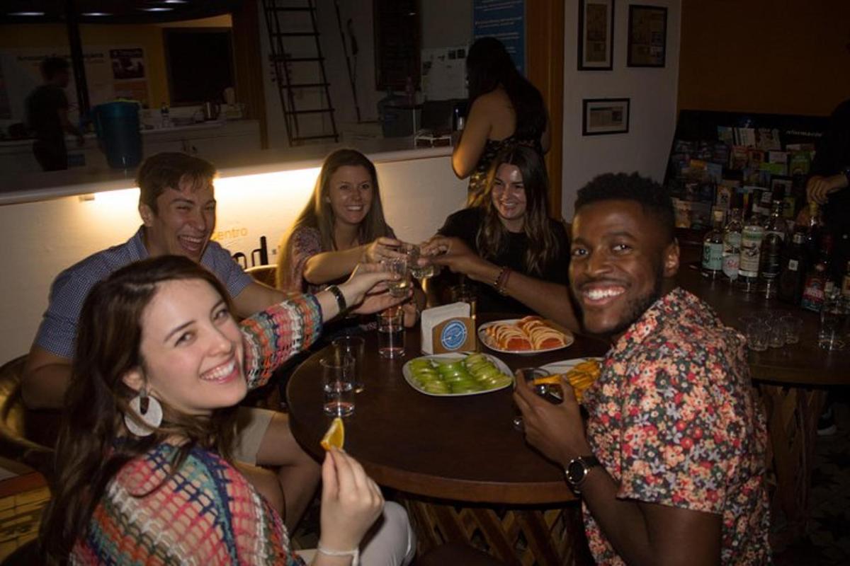 a group of people sitting around a table drinking wine