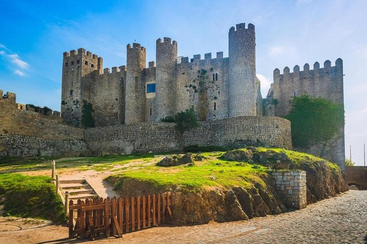a castle sitting on top of a grassy hill