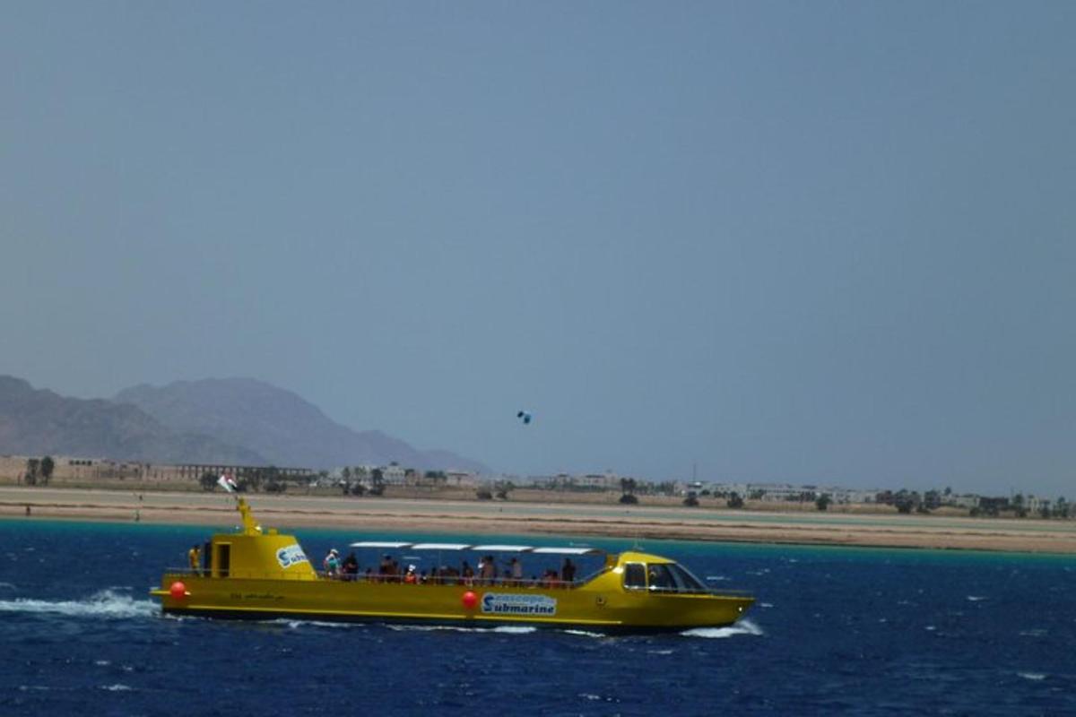 a yellow boat in the water on a body of water