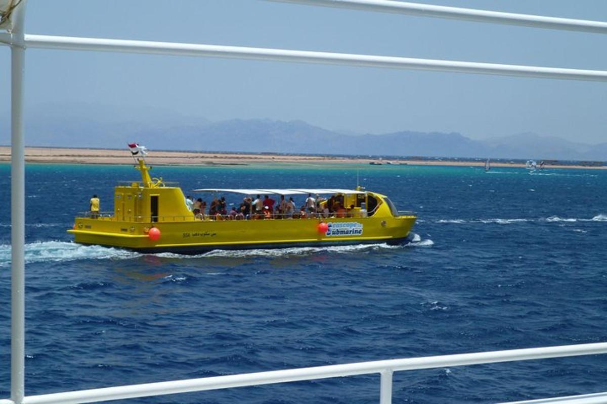 a yellow boat in the water with people on it