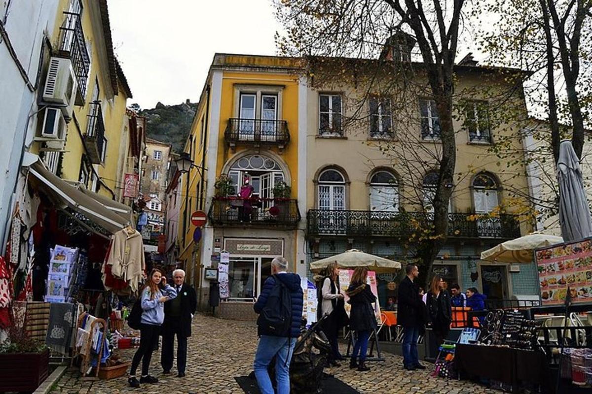 skupina lidí stojících na ulici s budovou