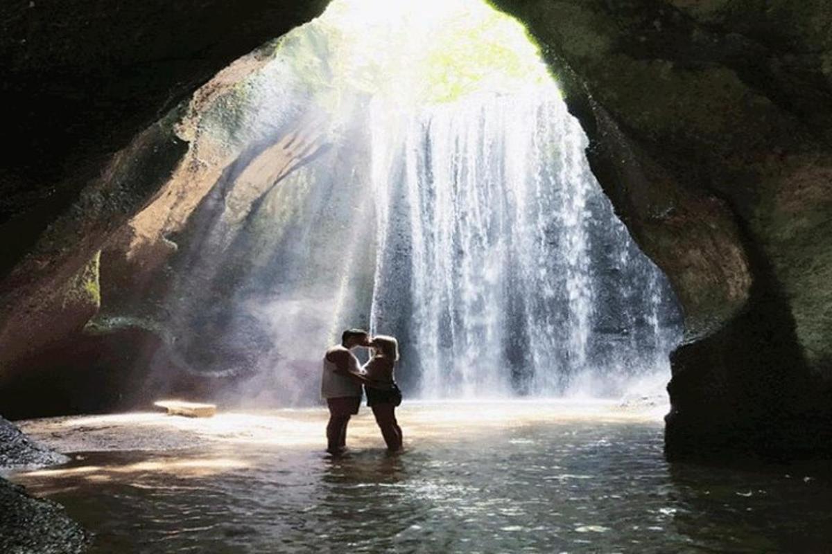 una coppia in piedi davanti a una cascata