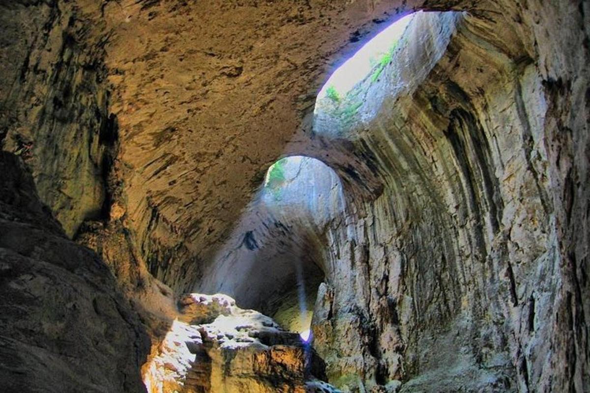un tunnel in una grotta con un fiume al suo interno