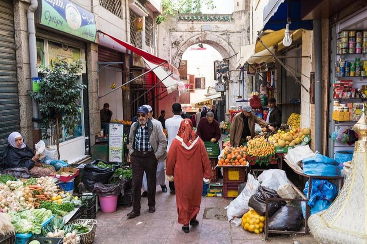 a group of people walking through an outdoor market