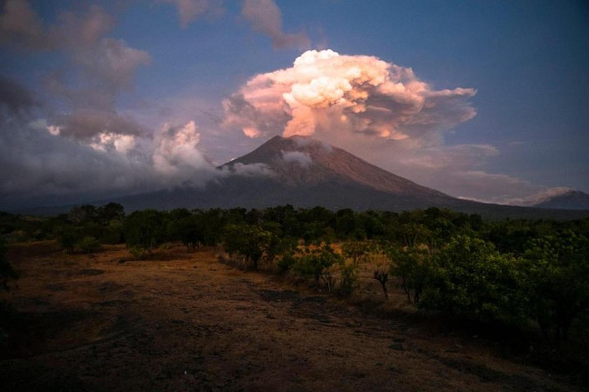 a volcano with a cloud of smoke on top of it