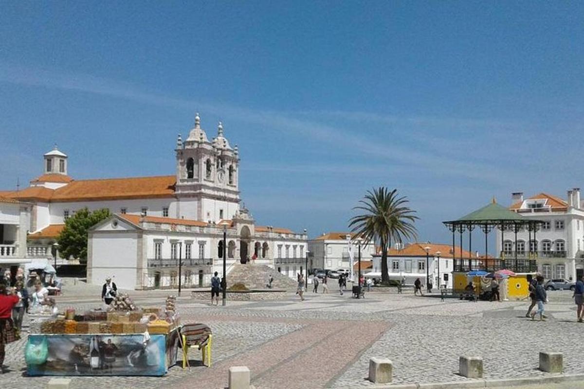 a city square with a large building with a clock tower