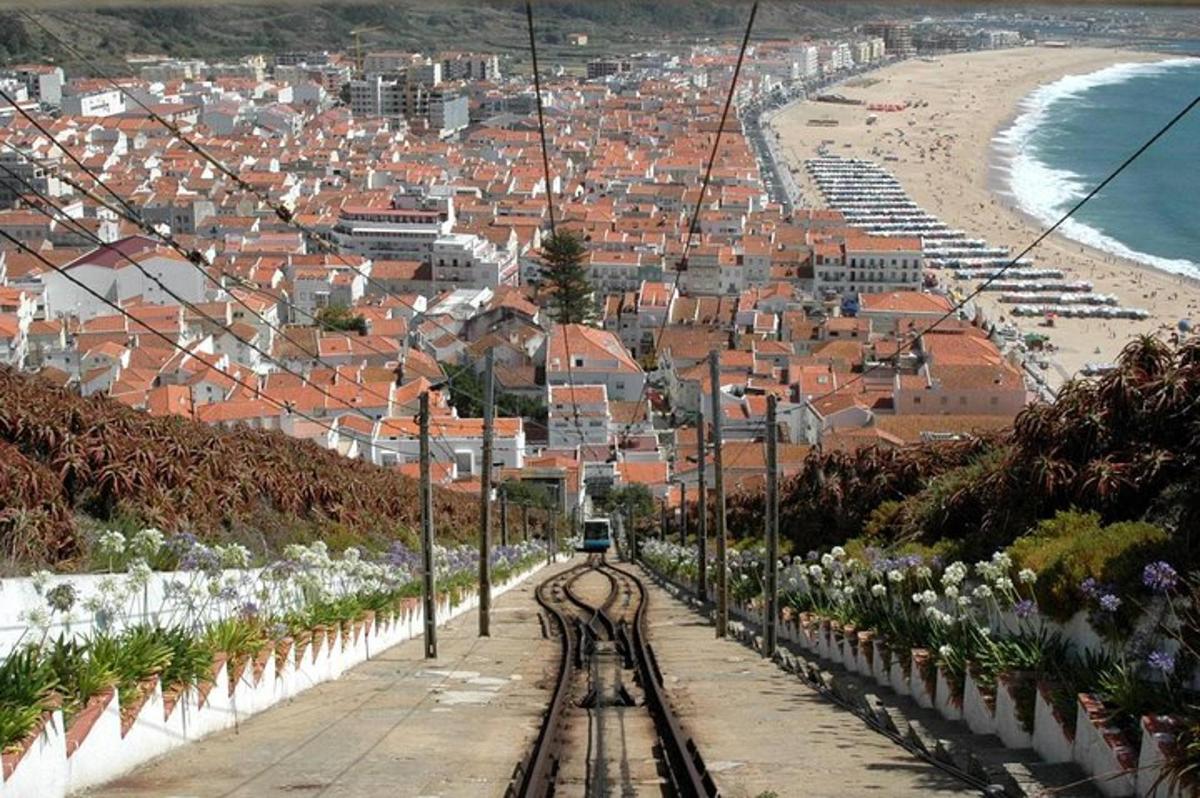 a train on a track in front of a beach