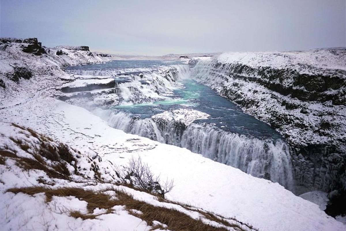 a waterfall is covered in snow and ice