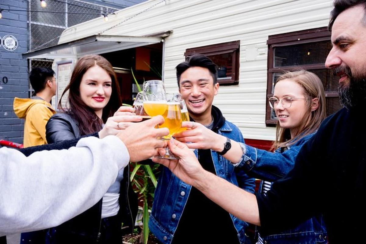 a group of people holding up glasses of beer