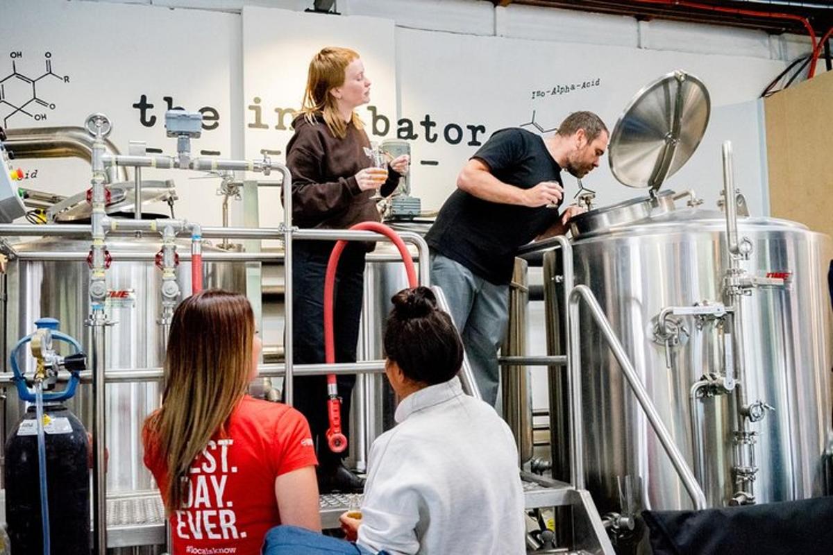a group of people standing around in a brewery