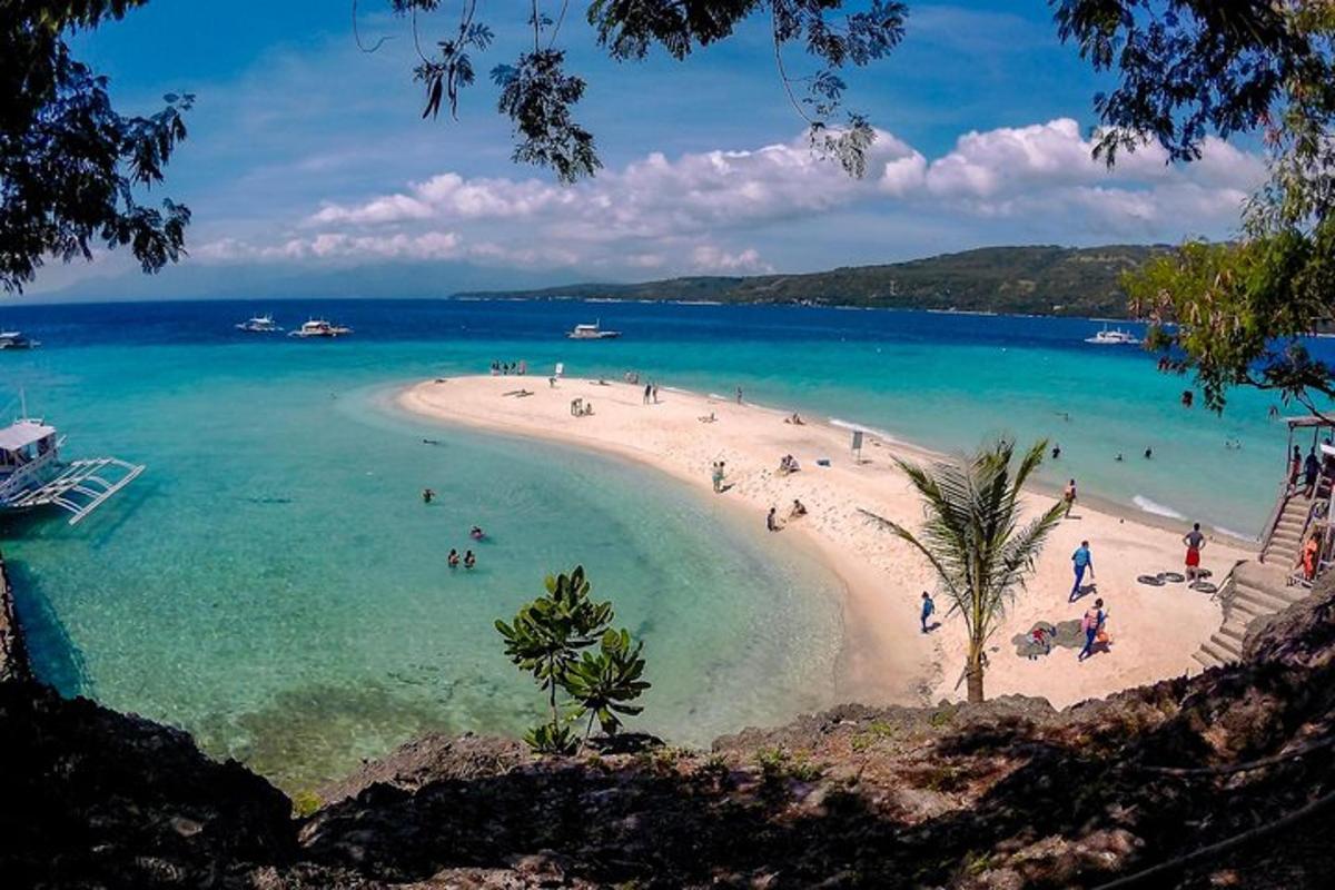 egy strand, ahol egy csomó ember van a vízben